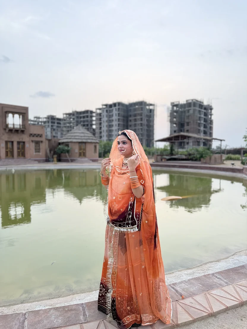Bindani Vibrant Three Orange Upada Rajputi Poshak Lehanga Set